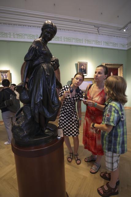 (260715) -- MOSCOW, July 15, 2026 (Xinhua) -- Tourists view a sculpture at an art museum in Yaroslavl, Russia, July 10, 2026. Russia's "Golden Ring" is a cultural and tourism route surrounding the capital of Moscow, which brings the history and culture, architectural art, folk customs and natural scenery of Russia to its viewers. (Xinhua/Zheng Yue)