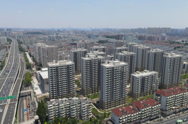 (260715) -- SHANGHAI, July 15, 2026 (Xinhua) -- An aerial drone photo taken on June 27, 2025 shows buildings of Pengyi residential compound after renewal in Jing'an District, east China's Shanghai. In Shanghai's Pengpu Xincun, one of the city's earliest newly built residential areas for in-service staff, senior residents like 92-year-old Yu Meixiang and 75-year-old Peng Juhua shared their memories of bygone days at a gathering with children of the neighborhood. Their stories reflect not only personal history but also a remarkable urban renewal that has transformed their lives while keeping their community intact.
   Built mostly in the 1950s and 1960s, the residential buildings in Pengpu Xincun had long fallen into disrepair, as could be seen in the leaky roofs and crumbling walls. The daily hardships had been worsened by kitchens and bathrooms shared among neighbors, especially when families there were growing in sizes. 
   In response, the local government launched a renewal project in 2005. Residents temporarily relocated while their old homes were reconstructed on the original plots. After two decades of work in multiple phases, Pengyi residential compound of Pengpu Xincun officially opened for its earlier residents to move back in June 2025.
   The refurbished apartments there are now more spacious, each with a private kitchen and bathroom. Elevators, barrier-free access, and a pedestrian-friendly internal traffic system are now in place to make life much easier for the elderly. A neighborhood cultural center with a library and gym is set to open soon. (Xinhua/Fang Zhe)