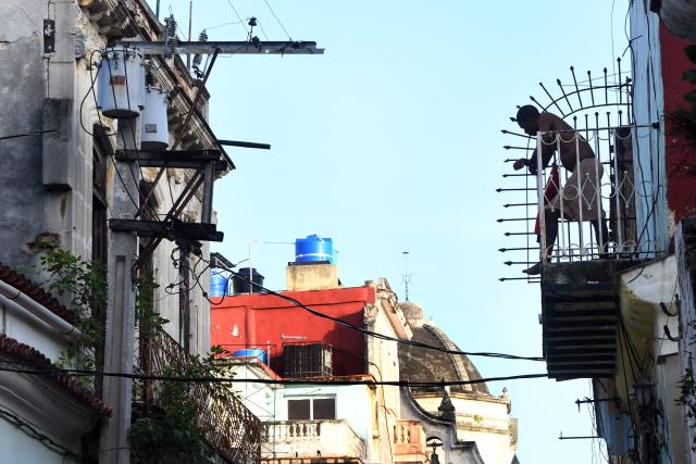 (260715) -- HAVANA, July 15, 2026 (Xinhua) -- A man stands on the balcony during a nationwide blackout in Havana, capital of Cuba, July 14, 2026. Cuba was hit by a third nationwide blackout in a little over a week on Tuesday, the National Electric Union said. (Photo by Joaquin Hernandez/Xinhua)