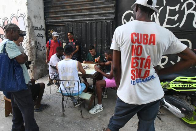 (260715) -- HAVANA, July 15, 2026 (Xinhua) -- People play dominoes on a street during a nationwide blackout in Havana, capital of Cuba, July 14, 2026. Cuba was hit by a third nationwide blackout in a little over a week on Tuesday, the National Electric Union said. (Photo by Joaquin Hernandez/Xinhua)