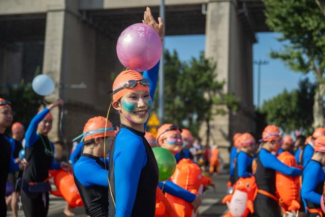 (260717) -- WUHAN, July 17, 2026 (Xinhua) -- Participants are pictured during the 51st edition of the Yangtze River crossing event in Wuhan, central China's Hubei Province, July 16, 2026. Located at the confluence of the Yangtze River and its longest tributary, the Han River, Wuhan is home to 165 rivers and 166 lakes. These abundant water resources foster a deep-seated love for open-water swimming among Wuhan's inhabitants.
   This year marks the 51st edition of the Yangtze River crossing event. During the competition, swimmers from around the country and the world gather on the banks of the Yangtze River to race across the river. Yet behind every crossing, members of a volunteer team, the Yangtze River volunteer lifeguard team, always safeguard participants' safety with passion, courage and selfless dedication.
   Zhou Zhuan, 64, is a detachment captain of the Yangtze River volunteer lifeguard Team. This year marks his fourth time participating in rescue support work during the river crossing event. As a native of Wuhan who grew up by the river, Zhou has a deep affection for the Yangtze River. Having loved swimming for many years and wishing to contribute to the community, Zhou joined the team after retiring from work in 2017.
   On regular days, Zhou and team members conduct swimming training and riverbank patrols, carry out simulated rescues, and deliver safety awareness outreach program. During the summer flood season, members of the team take turns on duty along the riverbank to respond to emergencies. Established in 2010, the team now comprises over 3,500 members and has rescued more than 1,200 people to date. (Xinhua/Du Zixuan)