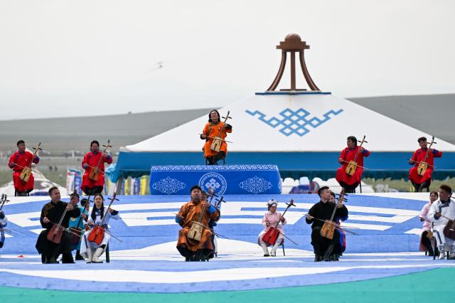 (260718) -- XILIN GOL, July 18, 2026 (Xinhua) -- Artists perform at the opening ceremony of the 36th Naadam festival in Xilin Gol League, north China's Inner Mongolia Autonomous Region, July 18, 2026. The Naadam festival kicked off here on Saturday. Naadam, usually held in mid-summer and sometimes in winter in pastoral areas of Inner Mongolia, means "games" in the Mongolian language. It often comprises wrestling, archery, and horse racing, also known as the "Three Games of Men." (Xinhua/Li Zhipeng)