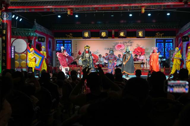(260718) -- CHENGDU, July 18, 2026 (Xinhua) -- Sichuan Opera performers perform face-changing on stage in Chengdu, southwest China's Sichuan Province, July 8, 2026. At 34, Yuan Xilin works as a ticket attendant at a Sichuan Opera theater in Chengdu, where he checks tickets, welcomes visitors and helps audiences find their way into the theater.
As Chengdu attracts growing numbers of international visitors interested in traditional Chinese opera and Sichuan Opera, Yuan meets dozens of overseas tourists every day. Hoping to make them feel more at ease, he began learning simple greetings in different languages so he could welcome them in their native tongue.
Yuan's interest in languages began in high school, when he came across a booklet introducing several foreign languages. Drawn to the rhythm of Spanish music and the sound of classical guitar, he developed a particular interest in Spanish.
As China's visa-free transit and other travel facilitation policies have brought more international visitors to the country, Yuan has expanded his language skills from English and Spanish to Italian, French, Portuguese, Russian, Polish and more. What once began with a simple greeting has gradually grown into brief conversations about visitors' experiences in China and introductions to Chengdu's local culture.
For Yuan, language is a bridge between cultures. He believes that even a simple greeting in a visitor's native language can make them feel welcome while creating opportunities for cultural exchange and his own personal growth. (Xinhua/Wang Xi)
