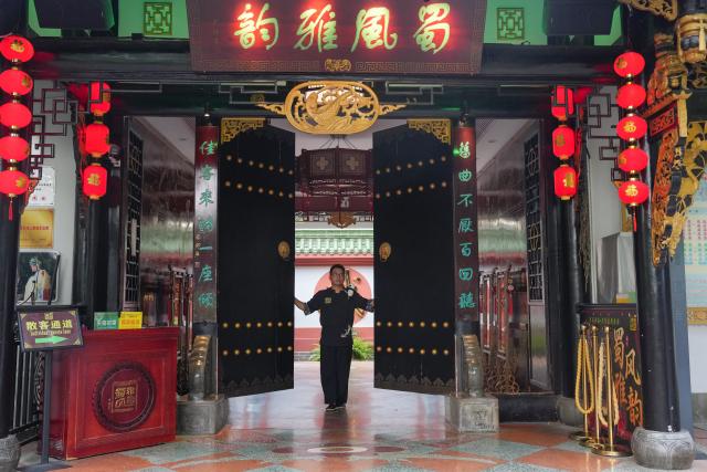 (260718) -- CHENGDU, July 18, 2026 (Xinhua) -- Yuan Xilin opens the door of a Sichuan Opera theater to prepare for welcoming guests in Chengdu, southwest China's Sichuan Province, July 8, 2026. At 34, Yuan Xilin works as a ticket attendant at a Sichuan Opera theater in Chengdu, where he checks tickets, welcomes visitors and helps audiences find their way into the theater.
As Chengdu attracts growing numbers of international visitors interested in traditional Chinese opera and Sichuan Opera, Yuan meets dozens of overseas tourists every day. Hoping to make them feel more at ease, he began learning simple greetings in different languages so he could welcome them in their native tongue.
Yuan's interest in languages began in high school, when he came across a booklet introducing several foreign languages. Drawn to the rhythm of Spanish music and the sound of classical guitar, he developed a particular interest in Spanish.
As China's visa-free transit and other travel facilitation policies have brought more international visitors to the country, Yuan has expanded his language skills from English and Spanish to Italian, French, Portuguese, Russian, Polish and more. What once began with a simple greeting has gradually grown into brief conversations about visitors' experiences in China and introductions to Chengdu's local culture.
For Yuan, language is a bridge between cultures. He believes that even a simple greeting in a visitor's native language can make them feel welcome while creating opportunities for cultural exchange and his own personal growth. (Xinhua/Wang Xi)