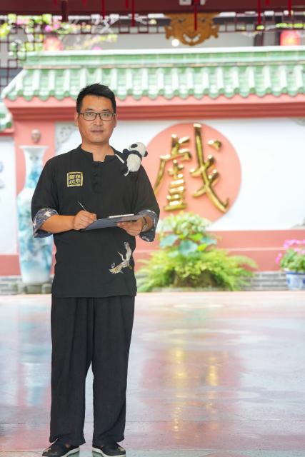 (260718) -- CHENGDU, July 18, 2026 (Xinhua) -- Yuan Xilin poses for a photo at a Sichuan opera theater in Chengdu, southwest China's Sichuan Province, July 8, 2026. At 34, Yuan Xilin works as a ticket attendant at a Sichuan Opera theater in Chengdu, where he checks tickets, welcomes visitors and helps audiences find their way into the theater.
As Chengdu attracts growing numbers of international visitors interested in traditional Chinese opera and Sichuan Opera, Yuan meets dozens of overseas tourists every day. Hoping to make them feel more at ease, he began learning simple greetings in different languages so he could welcome them in their native tongue.
Yuan's interest in languages began in high school, when he came across a booklet introducing several foreign languages. Drawn to the rhythm of Spanish music and the sound of classical guitar, he developed a particular interest in Spanish.
As China's visa-free transit and other travel facilitation policies have brought more international visitors to the country, Yuan has expanded his language skills from English and Spanish to Italian, French, Portuguese, Russian, Polish and more. What once began with a simple greeting has gradually grown into brief conversations about visitors' experiences in China and introductions to Chengdu's local culture.
For Yuan, language is a bridge between cultures. He believes that even a simple greeting in a visitor's native language can make them feel welcome while creating opportunities for cultural exchange and his own personal growth. (Xinhua/Wang Xi)