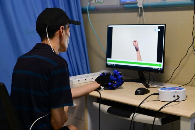 (260718) -- BENGBU, July 18, 2026 (Xinhua) -- A patient, who received Anhui's first semi-invasive brain-computer interface (BCI) surgery in April 2026, undergoes rehabilitation training at a hospital in Bengbu, east China's Anhui Province, July 17, 2026. Bengbu, a traditional industrial city, has stepped up the development of its brain-computer interface (BCI) industry in recent years. By strengthening collaboration among industry, research institutes and medical institutions, Bengbu has built an innovation ecosystem that supports both BCI research and clinical application, aiming to become an emerging BCI innovation hub in the Yangtze River Delta region. (Xinhua/Zhou Mu)