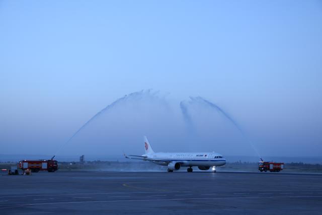 (260718) -- BISHKEK, July 18, 2026 (Xinhua) -- Flight CA893 passes through a water gate at the Manas International Airport in Bishkek, Kyrgyzstan, July 17, 2026. Air China's inaugural direct flight between the capitals of China and Kyrgyzstan officially launched on Friday after flight CA893, departing from Beijing Capital International Airport, successfully landed at Manas International Airport in Bishkek.
   According to Air China, regular flights in both directions of the new air service operate three times a week, namely on Mondays, Fridays, and Sundays. Flight CA893 departs from Beijing and travels to Bishkek, with a flight time of five hours 40 minutes; flight CA894 departs from Bishkek and travels to Beijing, with a flight time of four hours 50 minutes. (Photo by Liu Xiaowan/Xinhua)
