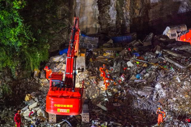 (260718) -- CHONGQING, July 18, 2026 (Xinhua) -- An aerial drone photo taken on July 18, 2026 shows rescuers working at the site of a landslide in Pengshui Miao and Tujia Autonomous County, southwest China's Chongqing Municipality. The geological disaster occurred at 9:08 a.m. on Friday in the Hanjia sub-district of Pengshui Miao and Tujia Autonomous County in Chongqing, burying more than 10 residential buildings. Search and rescue operations are still underway. (Xinhua/Huang Wei)