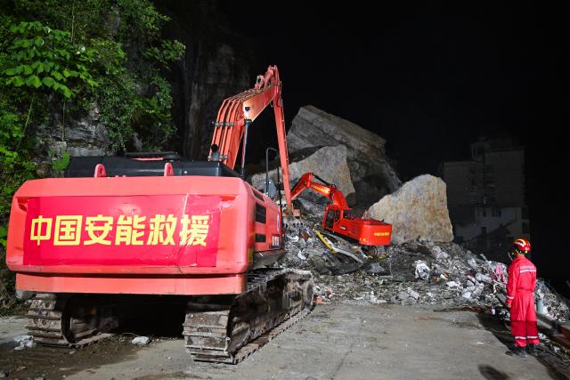 (260718) -- CHONGQING, July 18, 2026 (Xinhua) -- Rescuers work at the site of a landslide in Pengshui Miao and Tujia Autonomous County, southwest China's Chongqing Municipality, July 18, 2026. The geological disaster occurred at 9:08 a.m. on Friday in the Hanjia sub-district of Pengshui Miao and Tujia Autonomous County in Chongqing, burying more than 10 residential buildings. Search and rescue operations are still underway. (Xinhua/Wang Quanchao)