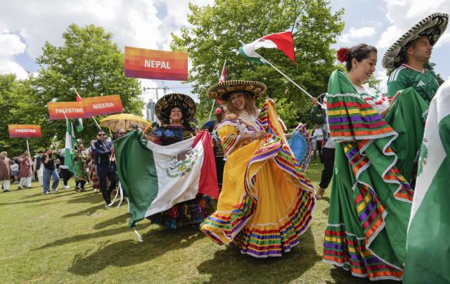 (260719) -- SURREY, July 19, 2026 (Xinhua) -- Participants in traditional costumes march during the Parade of Cultures at the Fusion Festival in Surrey, British Columbia, Canada, July 18, 2026.
  The two-day festival, which opened here on Saturday, featured over 50 cultural pavilions offering food, music, dance, and cultural performances from around the world. (Photo by Liang Sen/Xinhua)