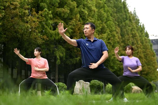 (260719) -- JINAN, July 19, 2026 (Xinhua) -- Zeela Nebulani (R) and Zoura Nebulani (L) practice Tai Chi with their teacher Li Ning at Rizhao Polytechnic University in Rizhao, east China's Shandong Province, July 16, 2026. Zeela Nebulani and Zoura Nebulani are sisters from Indonesia with ancestral roots in southeast China's Fujian Province. Growing up in a martial arts family, with both of their parents working as professional martial arts coaches, Zeela started martial arts training at the age of 6 and began practicing Tai Chi at 12. 
  In September 2024, Zeela enrolled at Rizhao Polytechnic University in east China's Shandong Province, where she majors in international trade. Inspired by her sister, Zoura enrolled at the same university this year and chose the same major.
   While studying at the university, the sisters not only focus on their academic studies, but also continue their daily martial arts training. In their spare time, they participate in campus cultural performances and exchange activities with young people from China and other countries. They also create bilingual short videos featuring Rizhao's coastal scenery, local folk traditions and daily life, sharing them on Indonesian social media platforms. They introduce Indonesian culture to their teachers and classmates, promoting cultural exchanges between China and Indonesia.
   Zeela and Zoura hope to serve as a cultural bridge between young people in China and Indonesia and contribute to closer friendship between the two countries. (Xinhua/Guo Xulei)