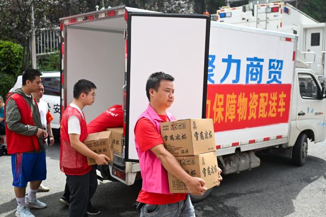(260719) -- CHONGQING, July 19, 2026 (Xinhua) -- Volunteers transfer supplies near the rescue site of a mountain collapse in Pengshui Miao and Tujia Autonomous County of Chongqing, southwest China, July 19, 2026. A rainfall-induced mountain collapse occurred at 9:08 a.m. on Friday in the Hanjia sub-district of Pengshui, burying more than 10 residential buildings, while leaving some local residents trapped and unaccounted for. 
  China activated a Level-II national emergency response for geological disasters. Multiple rescue forces including emergency response, fire control and public security rushed to the scene and launched full-scale search and rescue operations, while local residents also volunteered to take part in the rescue efforts. (Xinhua/Wang Quanchao)