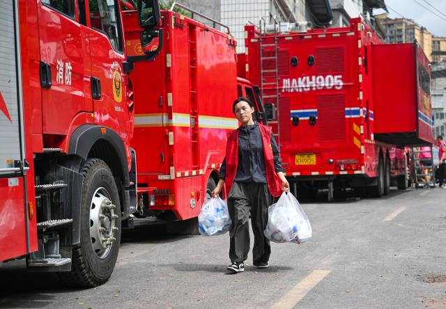 (260719) -- CHONGQING, July 19, 2026 (Xinhua) -- A volunteer carries supplies near the rescue site of a mountain collapse in Pengshui Miao and Tujia Autonomous County of Chongqing, southwest China, July 19, 2026. A rainfall-induced mountain collapse occurred at 9:08 a.m. on Friday in the Hanjia sub-district of Pengshui, burying more than 10 residential buildings, while leaving some local residents trapped and unaccounted for. 
  China activated a Level-II national emergency response for geological disasters. Multiple rescue forces including emergency response, fire control and public security rushed to the scene and launched full-scale search and rescue operations, while local residents also volunteered to take part in the rescue efforts. (Xinhua/Wang Quanchao)