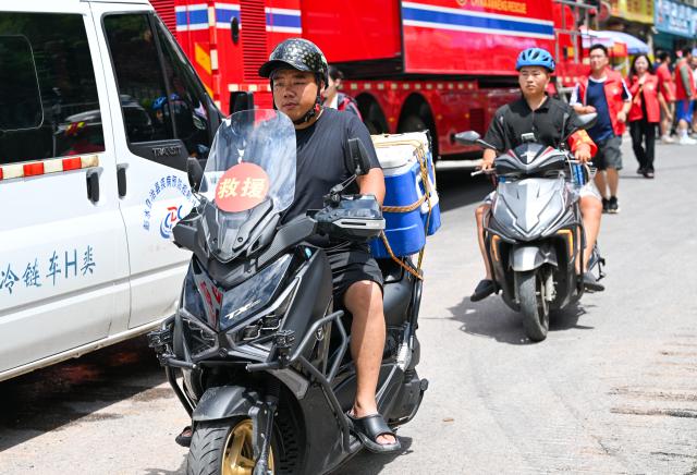 (260719) -- CHONGQING, July 19, 2026 (Xinhua) -- Motorcycle volunteers transport supplies near the rescue site of a mountain collapse in Pengshui Miao and Tujia Autonomous County of Chongqing, southwest China, July 19, 2026. A rainfall-induced mountain collapse occurred at 9:08 a.m. on Friday in the Hanjia sub-district of Pengshui, burying more than 10 residential buildings, while leaving some local residents trapped and unaccounted for. 
  China activated a Level-II national emergency response for geological disasters. Multiple rescue forces including emergency response, fire control and public security rushed to the scene and launched full-scale search and rescue operations, while local residents also volunteered to take part in the rescue efforts. (Xinhua/Wang Quanchao)