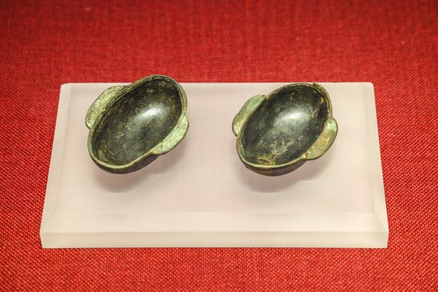 (260719) -- MAANSHAN, July 19, 2026 (Xinhua) -- This photo taken on July 18, 2026 shows drinking vessels displayed at an exhibition on lacquered wooden treasures at the Three Kingdoms Zhu Ran Family Cemetery Museum in Maanshan, east China's Anhui Province.
  The museum currently exhibits rare lacquered wooden treasures unearthed from the tomb of general Zhu Ran in the Eastern Wu Kingdom during the Three Kingdoms period (220-280). Among these masterpieces, lacquered wooden clogs are displayed to the public for the first time since they were excavated more than 40 years ago. (Photo by Wang Wensheng/Xinhua)