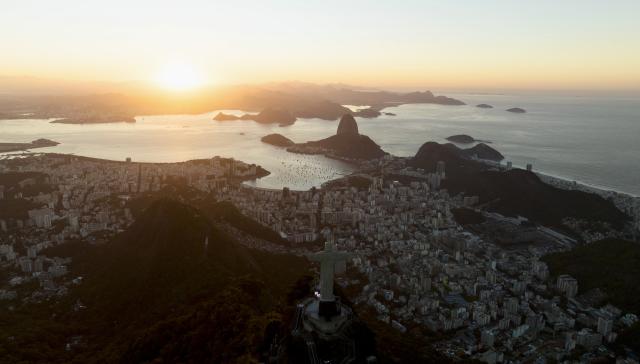 (260719) -- RIO DE JANEIRO, July 19, 2026 (Xinhua) -- An aerial drone photo taken on July 17, 2026 shows the Christ the Redeemer statue and the Guanabara Bay at sunrise in Rio de Janeiro, Brazil. Located on the Atlantic coast, Rio de Janeiro witnesses the landscapes of Atlantic rainforest, steep mountains and urban coastline in the city, forming its iconic landscape style. 
   In July 2012, some scenic spots in the city such as the Tijuca National Park, the Guanabara Bay, the Sugarloaf Mountain and the Copacabana Beach were inscribed on the World Heritage List by UNESCO under the name "Rio de Janeiro: Carioca Landscapes between the Mountain and the Sea." (Xinhua/Jin Haoyuan)