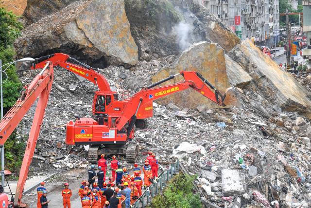 (260719) -- CHONGQING, July 19, 2026 (Xinhua) -- Rescuers work at the site of a mountain collapse in Pengshui Miao and Tujia Autonomous County of Chongqing, southwest China, July 19, 2026. A rainfall-induced mountain collapse occurred at 9:08 a.m. on Friday in the Hanjia sub-district of Pengshui, burying more than 10 residential buildings, while leaving some local residents trapped and unaccounted for.
   China activated a Level-II national emergency response for geological disasters. Multiple rescue forces including emergency response, fire control and public security rushed to the scene and launched full-scale search and rescue operations, while local residents also volunteered to take part in the rescue efforts. (Xinhua/Tang Yi)
