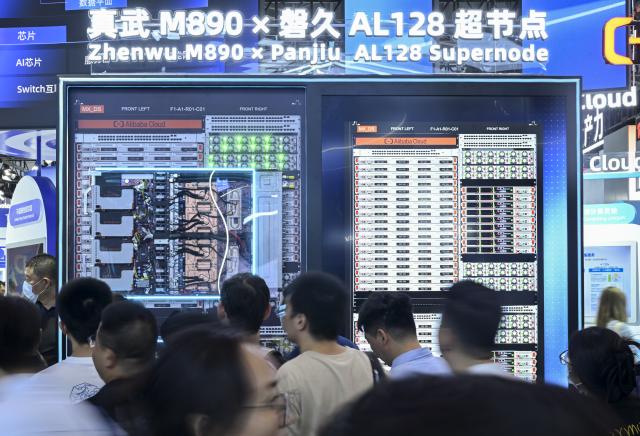 (260719) -- SHANGHAI, July 19, 2026 (Xinhua) -- People visit the Zhenwu M890 x Panjiu AL128 supernode displayed during the 2026 World AI Conference and High-Level Meeting on Global AI Governance in Shanghai, east China, July 19, 2026. The 2026 World AI Conference (WAIC) and High-Level Meeting on Global AI Governance opened here on Friday. A group of domestic supernode products draw public attentions during the event. (Xinhua/Chen Haoming)