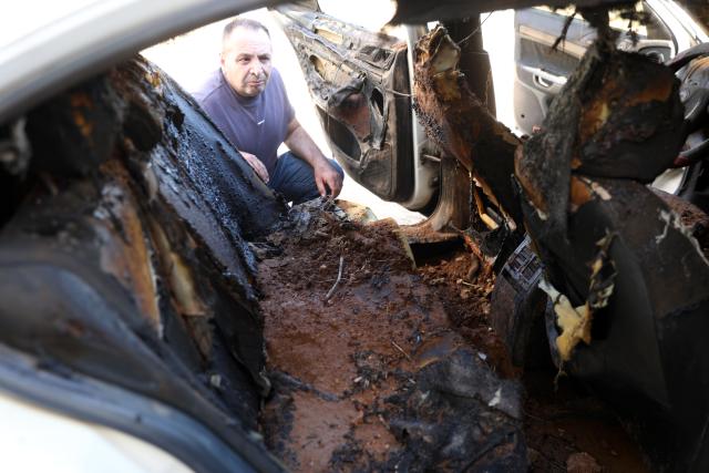(260720) -- HEBRON, July 20, 2026 (Xinhua) -- A Palestinian inspects a burned vehicle after Israeli settlers set fire to a mosque and homes in the village of Al-Tuwani in Masafer Yatta, southern West Bank city of Hebron, on July 19, 2026. (Photo by Mamoun Wazwaz/Xinhua)