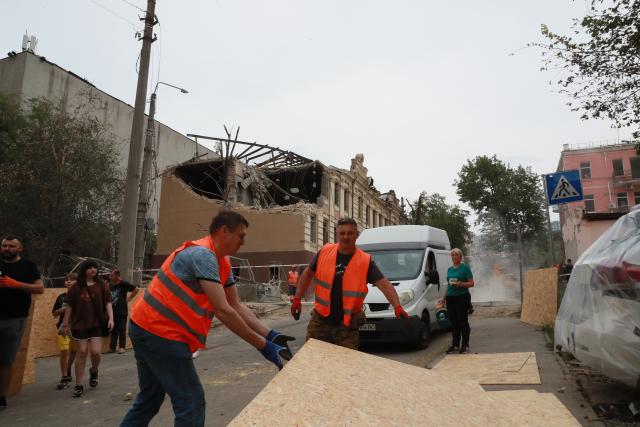 (260720) -- KIEV, July 20, 2026 (Xinhua) -- Staff members carry planks to reinforce doors and windows damaged in a Russian missile attack in Kiev, Ukraine, July 19, 2026. At least one person was killed and 13 others injured early Sunday in a Russian missile attack on Kiev, said Ukrainian authorities. (Xinhua/Li Dongxu)