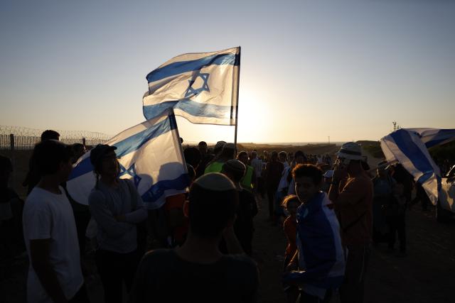 (260720) -- GAZA, July 20, 2026 (Xinhua) -- Israeli settler activists march on the Israeli side near the separation barrier with the Gaza Strip, calling for the reestablishment of Israeli settlements in the Gaza Strip, on July 19, 2026. (Photo by Jamal Awad/Xinhua)