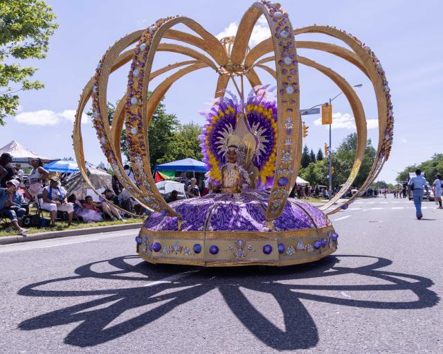(260720) -- TORONTO, July 20, 2026 (Xinhua) -- A dressed-up girl with her float is pictured during the Junior Carnival Parade of the 2026 Toronto Caribbean Carnival in Toronto, Canada, on July 19, 2026. Thousands of young participants in vivid costumes took part in the parade, celebrating Caribbean culture through music and dance. (Photo by Zou Zheng/Xinhua)