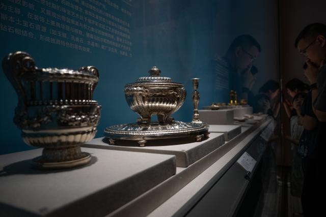 (260720) -- WUHAN, July 20, 2026 (Xinhua) -- Visitors view exhibits during the exhibition "Treasures of the Kremlin: From Peter the Great to Catherine the Great" at Hubei Provincial Museum in Wuhan, central China's Hubei Province, July 20, 2026. Jointly organized by Hubei Provincial Museum and the Moscow Kremlin Museums, the exhibition features 129 sets of precious artifacts dating from the 17th to 18th centuries, showcasing the rise, reforms and prosperity of the Russian Empire. (Xinhua/Du Zixuan)