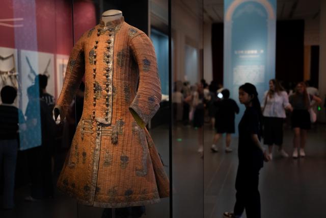 (260720) -- WUHAN, July 20, 2026 (Xinhua) -- People visit the exhibition "Treasures of the Kremlin: From Peter the Great to Catherine the Great" at Hubei Provincial Museum in Wuhan, central China's Hubei Province, July 20, 2026. Jointly organized by Hubei Provincial Museum and the Moscow Kremlin Museums, the exhibition features 129 sets of precious artifacts dating from the 17th to 18th centuries, showcasing the rise, reforms and prosperity of the Russian Empire. (Xinhua/Du Zixuan)