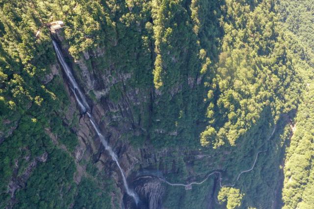 (260720) -- CHENGDU, July 20, 2026 (Xinhua) -- An aerial drone photo taken on July 19, 2026 shows the scenery of the Wawu Mountain in Hongya County, southwest China's Sichuan Province. Known for its distinctive table-mountain landform, Wawu Mountain features a summit plateau covering about 11 square kilometers, making it a popular tourist destination. (Xinhua/Xu Bingjie)
