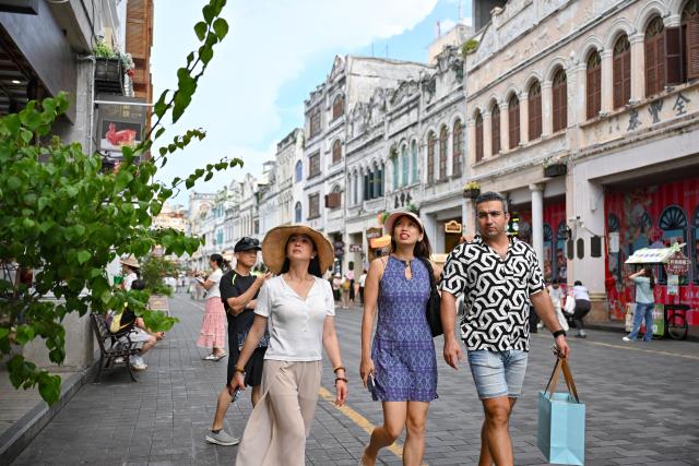 (260720) -- HAIKOU, July 20, 2026 (Xinhua) -- Tourists visit the Qilou Old Street in Haikou, south China's Hainan Province, July 18, 2026. Hainan is seeing a surge in visitors during the summer holiday season. (Xinhua/Guo Cheng)