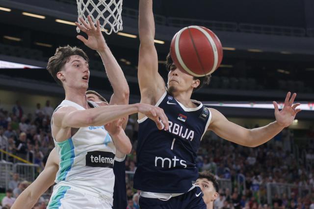 (260720) -- LJUBLJANA, July 20, 2026 (Xinhua) -- Mark Padjen (L) of Slovenia passes the ball during the final between Slovenia and Serbia at FIBA U20 EuroBasket 2026 in Ljubljana, Slovenia, July 19, 2026. (Photo by Zeljko Stevanic/Xinhua)