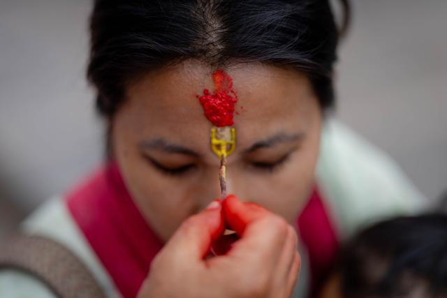 (260720) -- KATHMANDU, July 20, 2026 (Xinhua) -- A tika is seen on the forehead of a devotee after offering prayers on the first Monday of the holy month of Shrawan at the Pashupatinath Temple in Kathmandu, Nepal, on July 20, 2026. The holy month of Shrawan is considered auspicious by Hindus, who worship Lord Shiva and offer prayers seeking blessings, peace, and prosperity. (Photo by Sulav Shrestha/Xinhua)