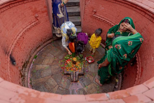 (260720) -- KATHMANDU, July 20, 2026 (Xinhua) -- Devotees offer prayers on the first Monday of the holy month of Shrawan at a Shiva temple in Kathmandu, Nepal, on July 20, 2026. The holy month of Shrawan is considered auspicious by Hindus, who worship Lord Shiva and offer prayers seeking blessings, peace, and prosperity. (Photo by Sulav Shrestha/Xinhua)