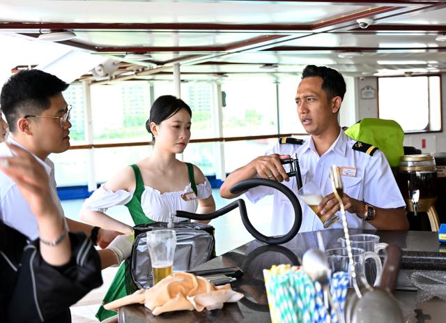 (260720) -- QINGDAO, July 20, 2026 (Xinhua) -- Staff members prepare beer for visitors aboard cruise ship Dream at Qingdao International Cruise Terminal in Qingdao, east China's Shandong Province, July 20, 2026. As a part of the 36th Qingdao International Beer Festival, a cruise tour event kicked off at the Qingdao International Cruise Terminal on Monday. Featuring live performances and interactive experiences, this event created an immersive maritime leisure space for visitors. (Xinhua/Li Ziheng)