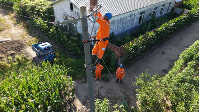 (260720) -- MUDANJIANG, July 20, 2026 (Xinhua) -- An aerial drone photo taken on July 20, 2026 shows staff members inspecting power lines for electricity restoration in Ning'an Township of Ning'an City, Mudanjiang, northeast China's Heilongjiang Province. Water supply and power departments in Mudanjiang have stepped up efforts to restore water and electricity services in the affected areas as flooding gradually recedes in the city. (Photo by Zhang Chunxiang/Xinhua)