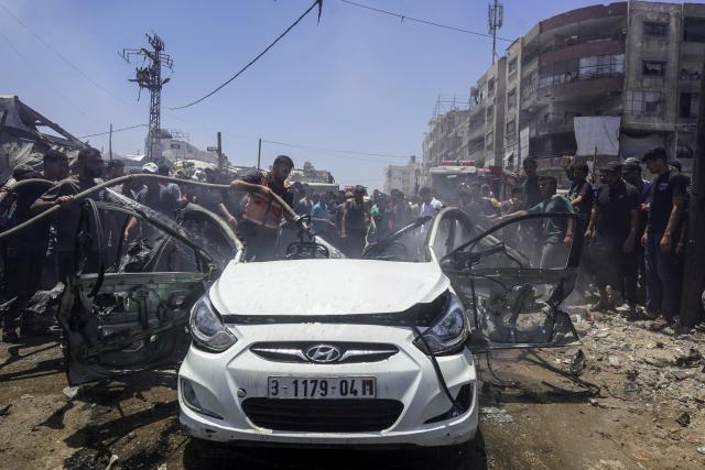 (260720) -- GAZA, July 20, 2026 (Xinhua) -- A firefighter extinguishes fire on a burned vehicle following an Israeli drone airstrike in Gaza City, on July 20, 2026. A drone struck a civilian vehicle in central Gaza City, injuring 14 people, including women and children, a source with the ambulance and emergency services told Xinhua. Four Palestinians were killed on Monday in two Israeli drone strikes targeting vehicles in the Gaza Strip, according to Palestinian security and medical sources. (Photo by Rizek Abdeljawad/Xinhua)