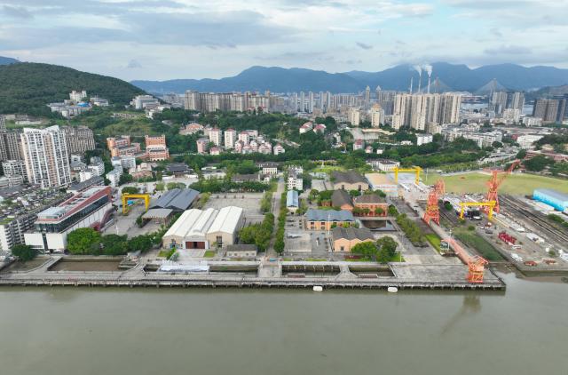 (260721) -- FUZHOU, July 21, 2026 (Xinhua) -- An aerial drone photo taken on July 18, 2026 shows a view of the China Shipyard Culture Park in Fuzhou, southeast China's Fujian Province. The China Shipyard Culture Park, opened in 2023 on the site of a century-old shipbuilding complex, preserves a collection of historic industrial buildings. The park combines exhibitions, educational programs, performances and tourism, showcasing China's modern shipbuilding heritage. (Xinhua/Lin Shanchuan)