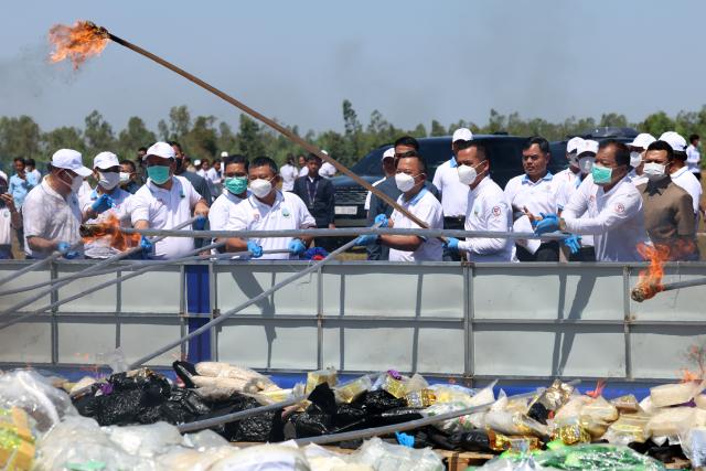 (260721) -- KANDAL, July 21, 2026 (Xinhua) -- Staff members set illicit drugs on fire during a drug-burning ceremony in Kandal province, Cambodia, July 21, 2026. Cambodia destroyed 5.62 tons of illicit drugs and precursor chemicals valued at 500 million U.S. dollars on Tuesday, Deputy Prime Minister and Interior Minister Sar Sokha said. (Photo by Sovannara/Xinhua)