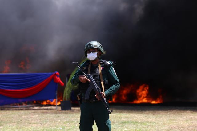 (260721) -- KANDAL, July 21, 2026 (Xinhua) -- An anti-drug police officer stands guard during a drug-burning ceremony in Kandal province, Cambodia, July 21, 2026. Cambodia destroyed 5.62 tons of illicit drugs and precursor chemicals valued at 500 million U.S. dollars on Tuesday, Deputy Prime Minister and Interior Minister Sar Sokha said. (Photo by Sovannara/Xinhua)