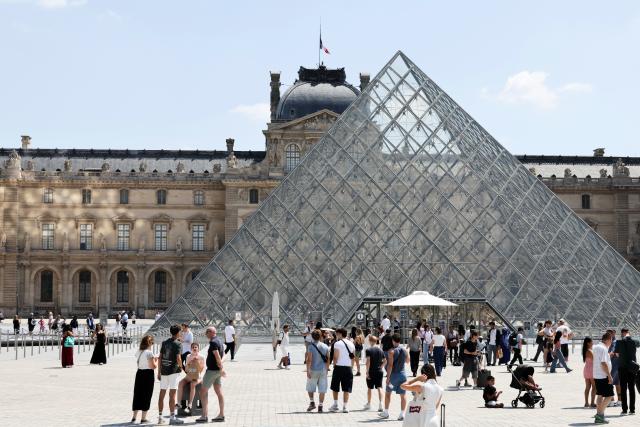 (260721) -- PARIS, July 21, 2026 (Xinhua) -- Tourists are pictured near the Louvre Museum in Paris, France, July 21, 2026. The Apollo Gallery at the Louvre Museum, which was robbed in October 2025, is set to reopen to the public on Wednesday, with no jewelry to be displayed, French media reported on Monday. (Xinhua/Wu Huiwo)