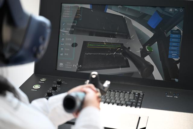 (260721) -- TIANJIN, July 21, 2026 (Xinhua) -- Rimaz Dakhilallah Aljohani tries welding with a VR device at the Tianjin Intelligent Manufacturing Branch of Offshore Oil Engineering Co., Ltd. (COOEC) in Tianjin, north China, July 9, 2026. Rimaz Dakhilallah Aljohani, a 22-year-old junior majoring in petroleum engineering at King Fahd University of Petroleum and Minerals (KFUPM) in Saudi Arabia, began a two-month internship and training program with six of her classmates at Offshore Oil Engineering Co., Ltd. (COOEC) in Tianjin during the summer vacation. 
  At the Tianjin Intelligent Manufacturing Branch of COOEC, she has experienced modern welding through VR technology, and learned about technologies behind China's modular construction and manufacturing of offshore oil and gas equipment.
  In 2022, China and Saudi Arabia signed the implementation plan for the synergy between the Belt and Road Initiative and Saudi Arabia's Vision 2030. The KFUPM-COOEC internship program represents a concrete practice in implementing the plan and provides a platform for youth exchanges.
  "The level of intelligent manufacturing and standardized project management here has greatly impressed me," Rimaz said. "I truly value this opportunity for international practical training. It has allowed me to gain first-hand knowledge of China's experience in the offshore oil industry. I hope to bring what I have learned back to Saudi Arabia and contribute to China-Saudi Arabia energy cooperation." (Xinhua/Sun Fanyue)