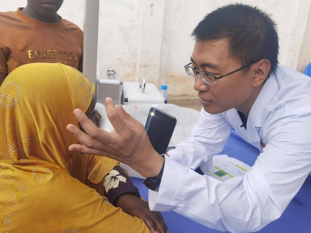 (260721) -- DAR ES SALAAM, July 21, 2026 (Xinhua) -- A doctor from the 28th batch of the Chinese medical team to the Tanzanian mainland examines a girl in Dar es Salaam, Tanzania, July 19, 2026.
  TO GO WITH "Chinese medical team provides free healthcare services at Tanzanian orphanage" (The 28th batch of the Chinese medical team to the Tanzanian mainland/Handout via Xinhua)