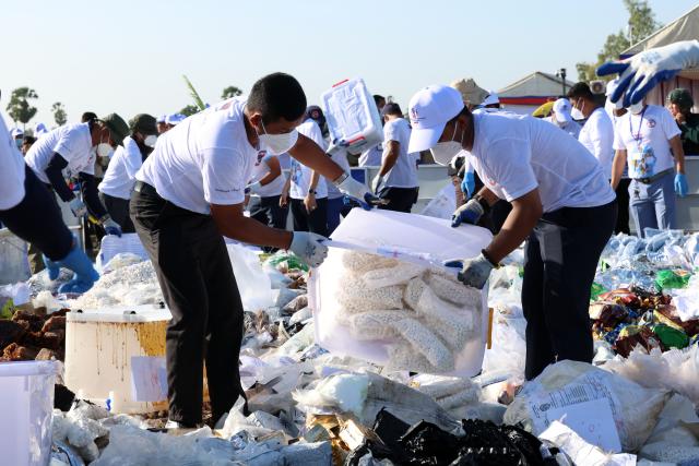 (260722) -- BEIJING, July 22, 2026 (Xinhua) -- Staff members arrange seized illicit drugs for a drug-burning ceremony in Kandal province, Cambodia, July 21, 2026. Cambodia destroyed 5.62 tons of illicit drugs and precursor chemicals valued at 500 million U.S. dollars on Tuesday, Deputy Prime Minister and Interior Minister Sar Sokha said. (Photo by Sovannara/Xinhua)