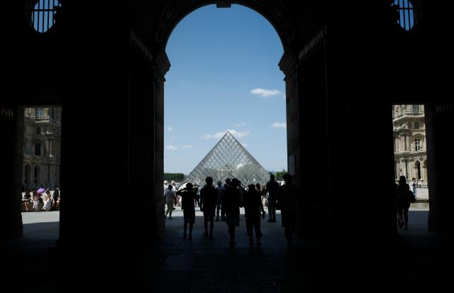 (260722) -- BEIJING, July 22, 2026 (Xinhua) -- Tourists are pictured near the Louvre Museum in Paris, France, July 21, 2026. The Apollo Gallery at the Louvre Museum, which was robbed in October 2025, is set to reopen to the public on Wednesday, with no jewelry to be displayed, French media reported on Monday. (Xinhua/Wu Huiwo)