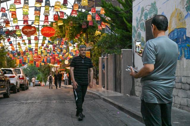 (260722) -- AMMAN, July 22, 2026 (Xinhua) -- A man poses for a photo at the Rainbow Street in Amman, Jordan, on July 20, 2026. Amman is the capital of Jordan where tradition and modernity coexist. From the ancient Citadel to the modern shopping district, traces of different eras intertwine to reveal the city's unique charm and enduring vitality. (Xinhua/Xin Mengchen)