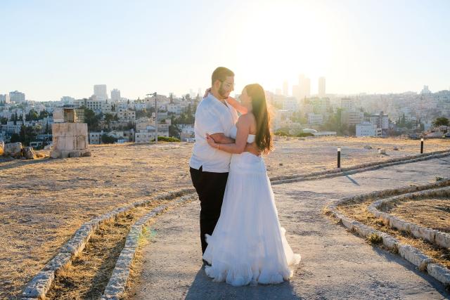 (260722) -- AMMAN, July 22, 2026 (Xinhua) -- Tourists have wedding photos taken at the Citadel in Amman, Jordan, on July 20, 2026. Amman is the capital of Jordan where tradition and modernity coexist. From the ancient Citadel to the modern shopping district, traces of different eras intertwine to reveal the city's unique charm and enduring vitality. (Xinhua/Xin Mengchen)