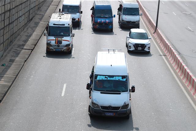 (260722) -- ABIDJAN, July 22, 2026 (Xinhua) -- Several minibuses operate on a road in Abidjan, Cote d'Ivoire, on July 21, 2026. Colorful minibuses serve as a primary mode of transport and a vibrant element of local street culture in Abidjan, the economic capital of Cote d'Ivoire. (Photo by Yvan Sonh/Xinhua)