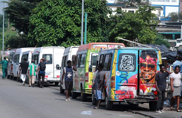 (260722) -- ABIDJAN, July 22, 2026 (Xinhua) -- A row of minibuses wait for passengers in Abidjan, Cote d'Ivoire, on July 21, 2026. Colorful minibuses serve as a primary mode of transport and a vibrant element of local street culture in Abidjan, the economic capital of Cote d'Ivoire. (Photo by Yvan Sonh/Xinhua)