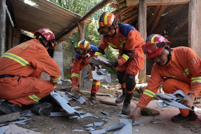 (260722) -- MOJIANG, July 22, 2026 (Xinhua) -- Firefighters clear debris at Jingping Village in Yutang Town of Mojiang Hani Autonomous County, southwest China's Yunnan Province, on July 22, 2026. The Yunnan provincial earthquake relief headquarters has activated a Level-IV emergency response after a 5.0-magnitude earthquake jolted Mojiang on Tuesday, local authorities said.
   No casualties have been reported so far. (Xinhua/Chen Xinbo)