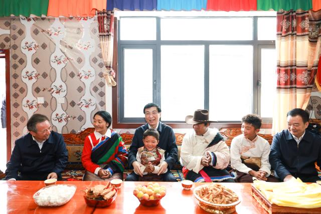 (260722) -- LHASA, July 22, 2026 (Xinhua) -- Wang Huning, a member of the Standing Committee of the Political Bureau of the Communist Party of China (CPC) Central Committee and chairman of the National Committee of the Chinese People's Political Consultative Conference, visits villagers in Zanda County of Ngari Prefecture, southwest China's Xizang Autonomous Region, July 21, 2026. Wang made a research tour in Xizang from July 19 to 22. (Xinhua/Liu Bin)